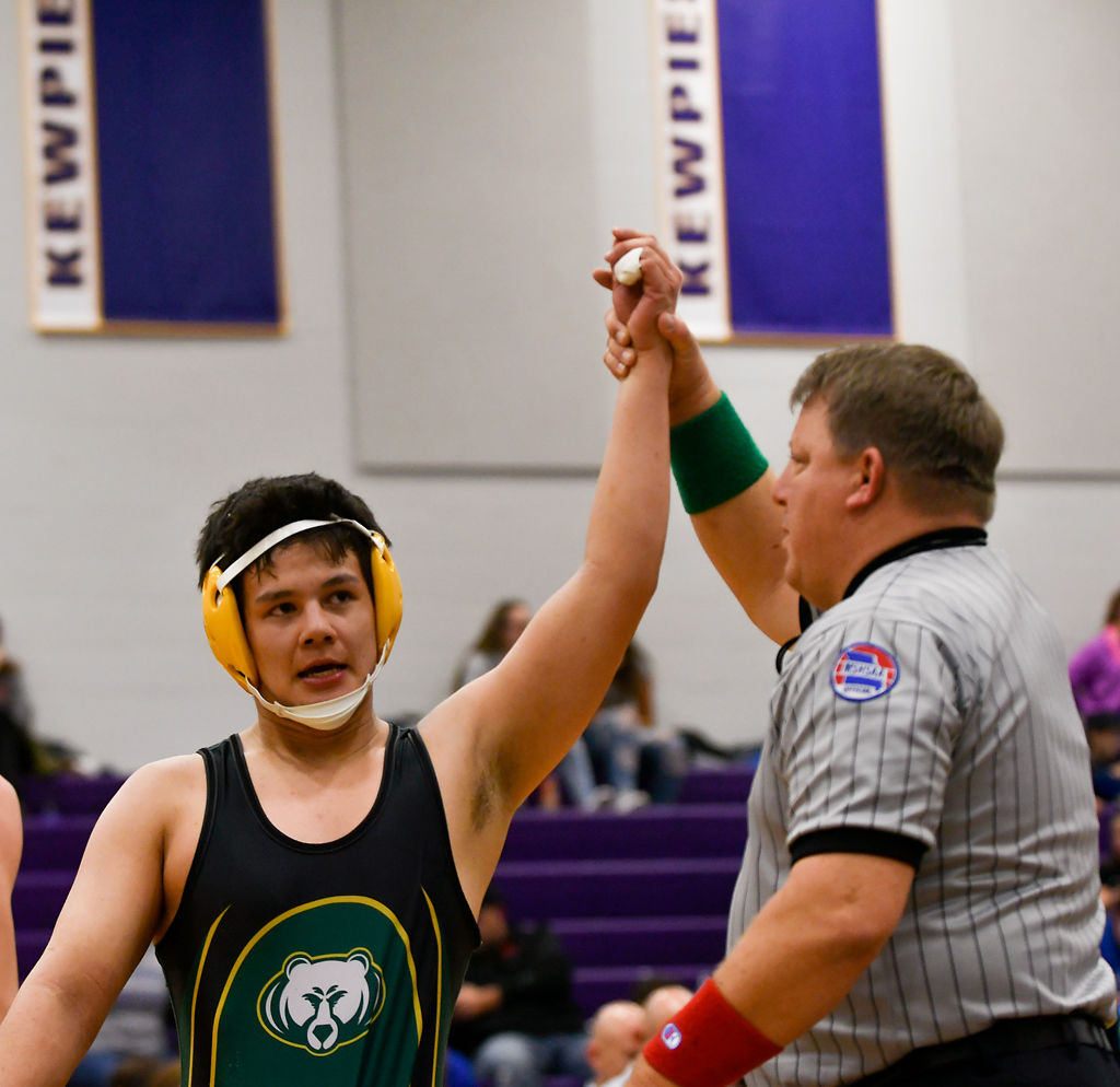 Rock Bridge's Zach Tran raises his hand in victory